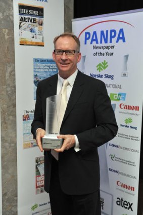 Editor of The Age, Paul Ramadge with the PANPA Newspaper of the Year trophy.