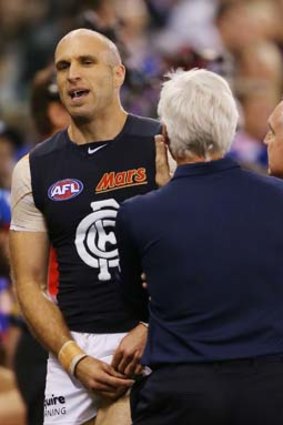 Chris Judd speaks to coach Mick Malthouse after limping off the ground with a leg injury only minutes after entering the field as a sub.