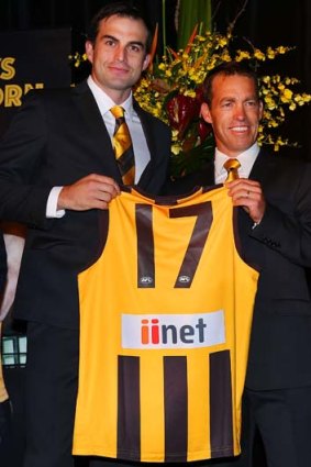 Hawks coach Alastair Clarkson presents Brian Lake his jumper during the club's season launch and Hall of Fame presentation on March 21.