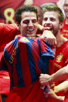 Spain's Cesc Fabregas (left) with a Barca shirt during World Cup celebrations.
