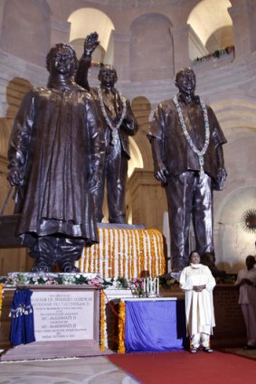 Uttar Pradesh state chief minister Mayawati, bottom right, stands near a statue of herself.