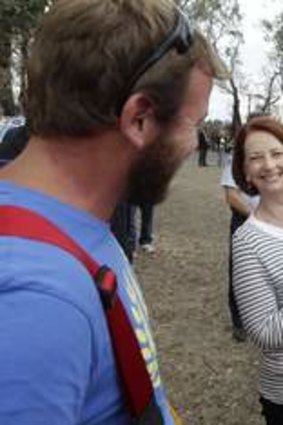 Prime Minister Julia Gillard cuddles 5 month old Edith Lukjanov when she met her firefighter dad Thayer from the Seaton Brigade when she toured bushfire affected areas in Gippsland, Victoria.