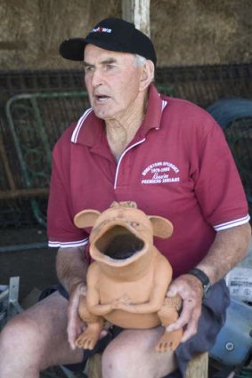 Dairy farmer Ken Sharpe with his ceramic "bunyip".