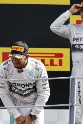 Finished second: Nico Rosberg watches on as Lewis Hamilton takes the plaudits.