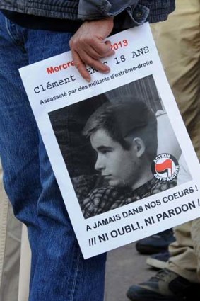 A demonstrator holds a poster of Clement Meric during a protest rally in Paris.