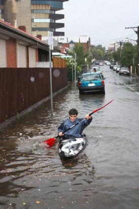 Matthieu Filippini paddling in the flooded streets of Richmond.