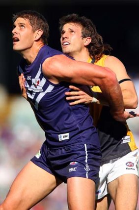 The late inclusion of Aaron Sandilands, seen here waiting for a throw-in with Tiger Ivan Maric, in the Dockers team on Saturday has led to a 'please explain' from the league.