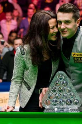 England's Mark Selby and his wife, Vikki Layton, pose with the trophy after he defeated Australia's Neil Robertson.