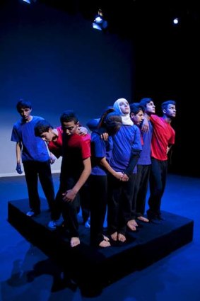 Cast members performing <em>Tree of Life</em>, which incorporates refugee students' stories.