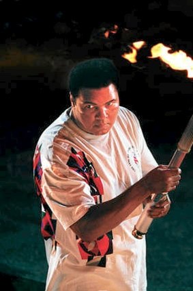 Muhammad Ali prepares to light the Olympic flame in the opening ceremony for the 1996 Atlanta Olympics.