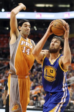Warriors centre Andrew Bogut tries to evade Suns forward Luis Scola during Golden State's nail-biting win in Phoenix.