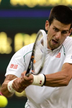 No, that's not a cheese ball he's hitting. Novak Djokovic hits a backhand on the court.