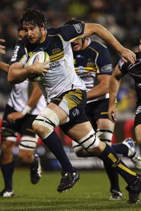 Sam Carter of the Brumbies runs the ball against the Sharks.