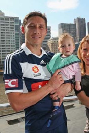 Mark Milligan poses with his daughters, Maya and Audrey, and his wife, Rhia Milligan, in Melbourne on Tuesday.