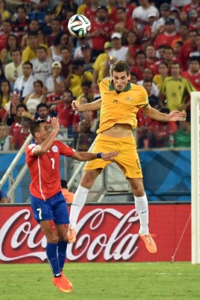 Matthew Spiranovic towers over Alexis Sanchez in the the Pantanal Arena.