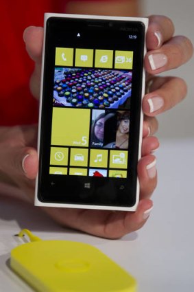 The new Nokia Lumia 920 is displayed with a charging mat.