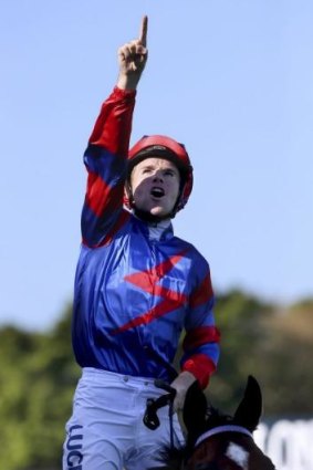 For Nathan: Berry points to the heavens after winning the Randwick miler.