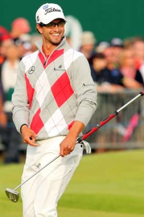 Adam Scott smiles as he walks onto the 18th green during his third round on day three of the British Open.