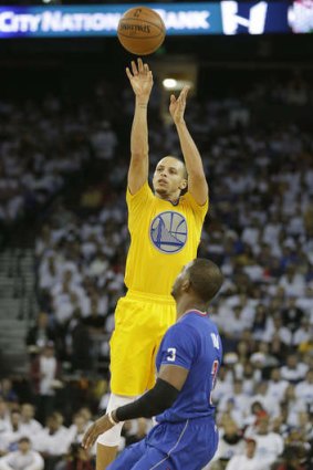Golden State Warriors guard Stephen Curry takes a shot over Los Angeles Clippers counterpart Chris Paul.