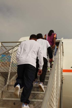 Sri Lankan men leaving Christmas Island for Colombo last week. They were followed by a second voluntary group yesterday.