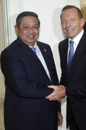 Indonesian President Susilo Bambang Yudhoyono greets Tony Abbott before a meeting at the presidential palace in Jakarta.