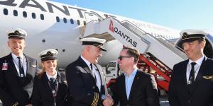 Alan Joyce,Qantas Group CEO,far right,with the flight deck crew and cabin crew at Sydney Airport celebrating after flying 19 hours and 16 minutes from New York to Sydney.