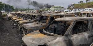 Burnt cars are lined up after unrest that erupted following protests over voting reforms in Noumea,New Caledonia.