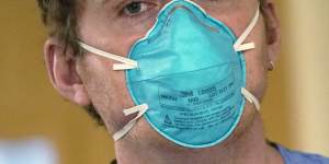 A registered nurse wears an N95 mask.