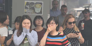 The blanket of smoke makes conditions in Sydney's CBD unpleasant for people during lunch time. 