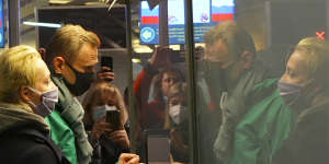 In this grab taken from video,Alexei Navalny and his wife Yulia stand at the passport control before Navalny was detained by police after arriving at Sheremetyevo airport,outside Moscow.