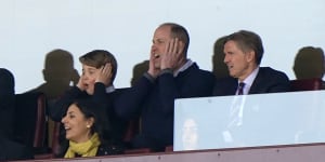 Britain’s Prince William and Prince George (left) watch an English Premier League soccer match in April.