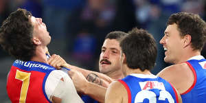 Tom Liberatore of the Bulldogs and Jarrod Berry of the Lions clash.