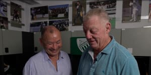 Eddie Jones and Phil Gould look at some old Randwick rugby pictures at Coogee Oval.