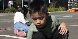 Juliana Lee’s son Ashton,7,plays in a car park in Wentworth Point with his cousin.