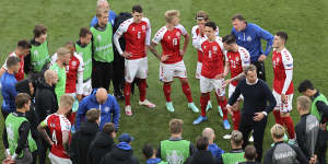Denmark’s manager Kasper Hjulmand speaks to his players after Christian Eriksen’s cardiac arrest during the game against Finland.