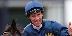 John Allen celebrates after riding Strictly Business to victory in the Oaks. 