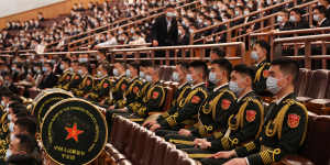 Members of the People’s Liberation Army (PLA) band sit during the opening session of the 20th National Congress.