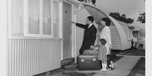 A migrant family enters their new home with hopeful faces at Maribyrnong,Victoria,1965. Nissen huts were a common feature of life in a"silver city".