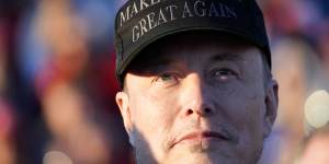 Tesla and SpaceX CEO Elon Musk listens as Republican presidential nominee Donald Trump speaks at a campaign event in Pennsylvania.