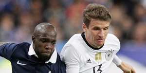 French footballer Lassana Diarra competes with German opponent Thomas Mueller during the match.