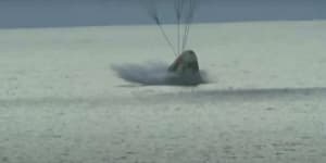 The SpaceX capsule splashes down in the Atlantic.