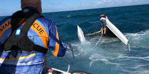 Man swims kilometre in rough seas while woman clings to vessel