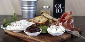 Altogether now:Italian brekkie board with two poached eggs,prosciutto,avocado,Persian feta and marinated olives served with sourdough.