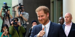 Prince Harry gives a thumbs up as he leaves after giving evidence in the Mirror Group phone hacking trial at London’s High Court in June.