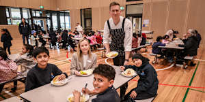 Chef Michael Galton-Fenzi serving lunch to principal Bec Spink and students Kevin Patel,Kabir Sharma-Fenzi and Riva Shah.