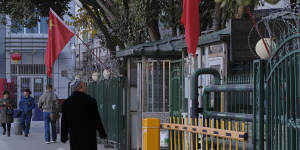 A man stares at a heavily fenced and gated mosque in the Xinjiang capital,Urumqi.