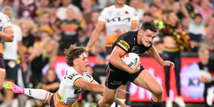 Nathan Cleary powers past Reece Walsh towards the try line.