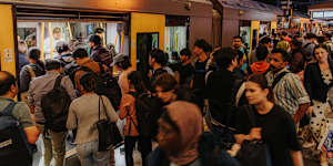 Passengers board a train at Parramatta station during the evening peak on Tuesday.