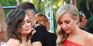 Lisa Wilkinson and Carrie Bickmore keep an eye on social media before launching on to the Logies red carpet last Sunday.