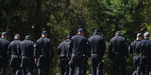 NSW Police conduct a line search walking towards the mound of dirt where the bodies believed to be Luke Davies and Jesse Baird were discovered.